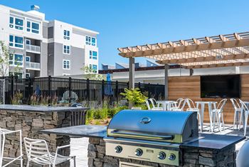 Terrace deck featuring two fire pits & outdoor tv